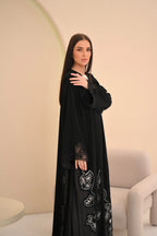 Black Nida abaya with geometric laser-cut hem and Dori handwork — Al Anood UAE