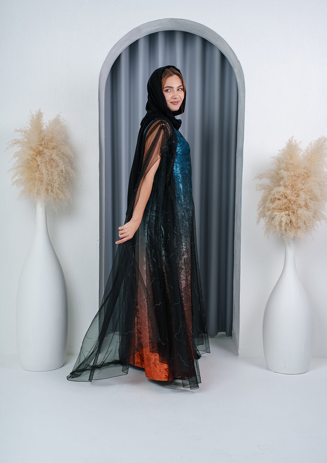 Black sheer tulle abaya with crystal lines over teal velvet dress — Al Anood UAE