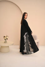 Black abaya seated view — dramatic sheer side panels Al Anood UAE