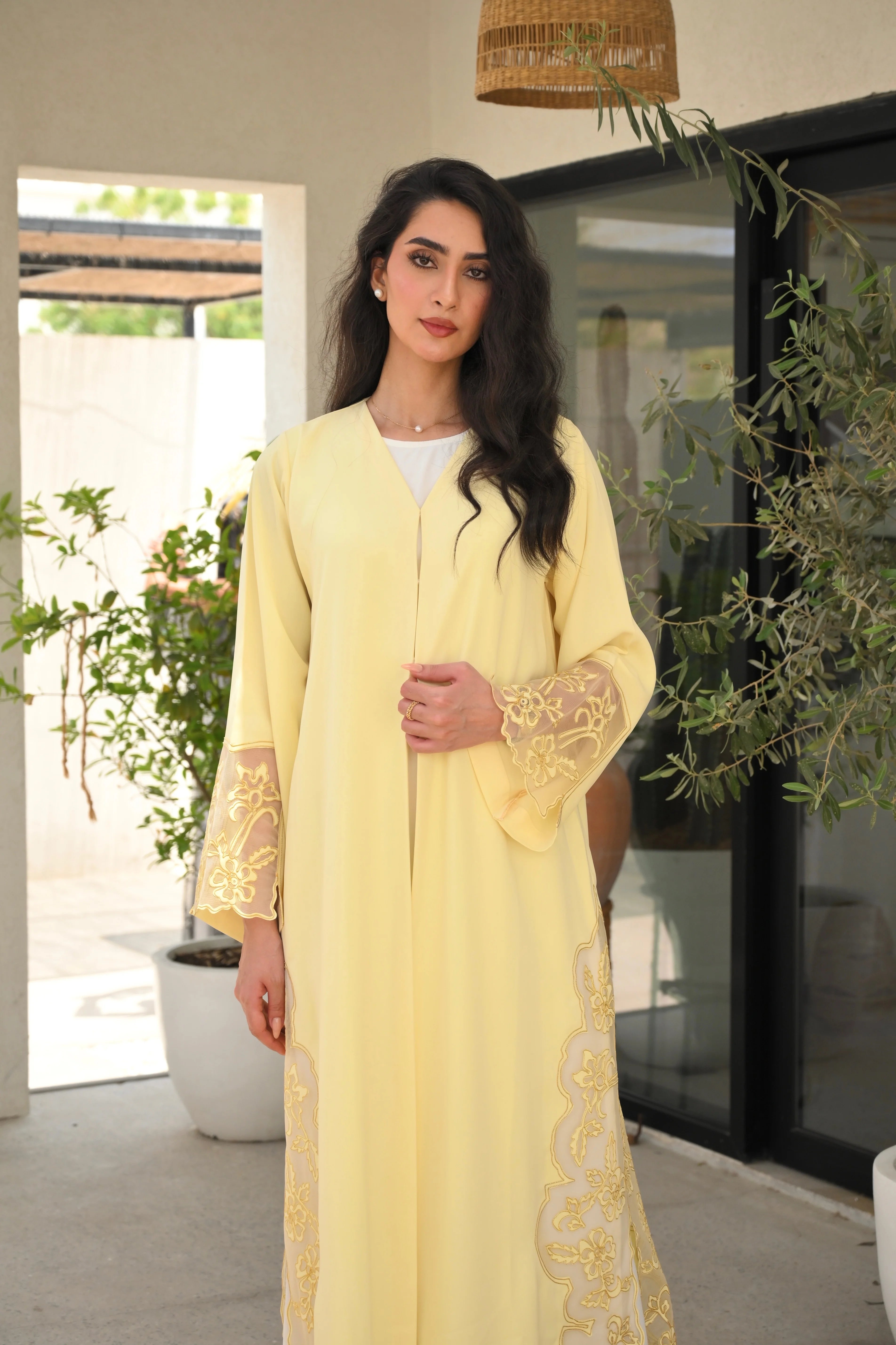 Light yellow Emirati abaya with laser cut details and Dori embroidery on sleeves and side panels