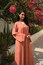 Luxury coral pink Emirati abaya with laser cut details and Aari embroidery