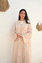 Soft beige Emirati abaya with laser embroidery on the chest and sleeves