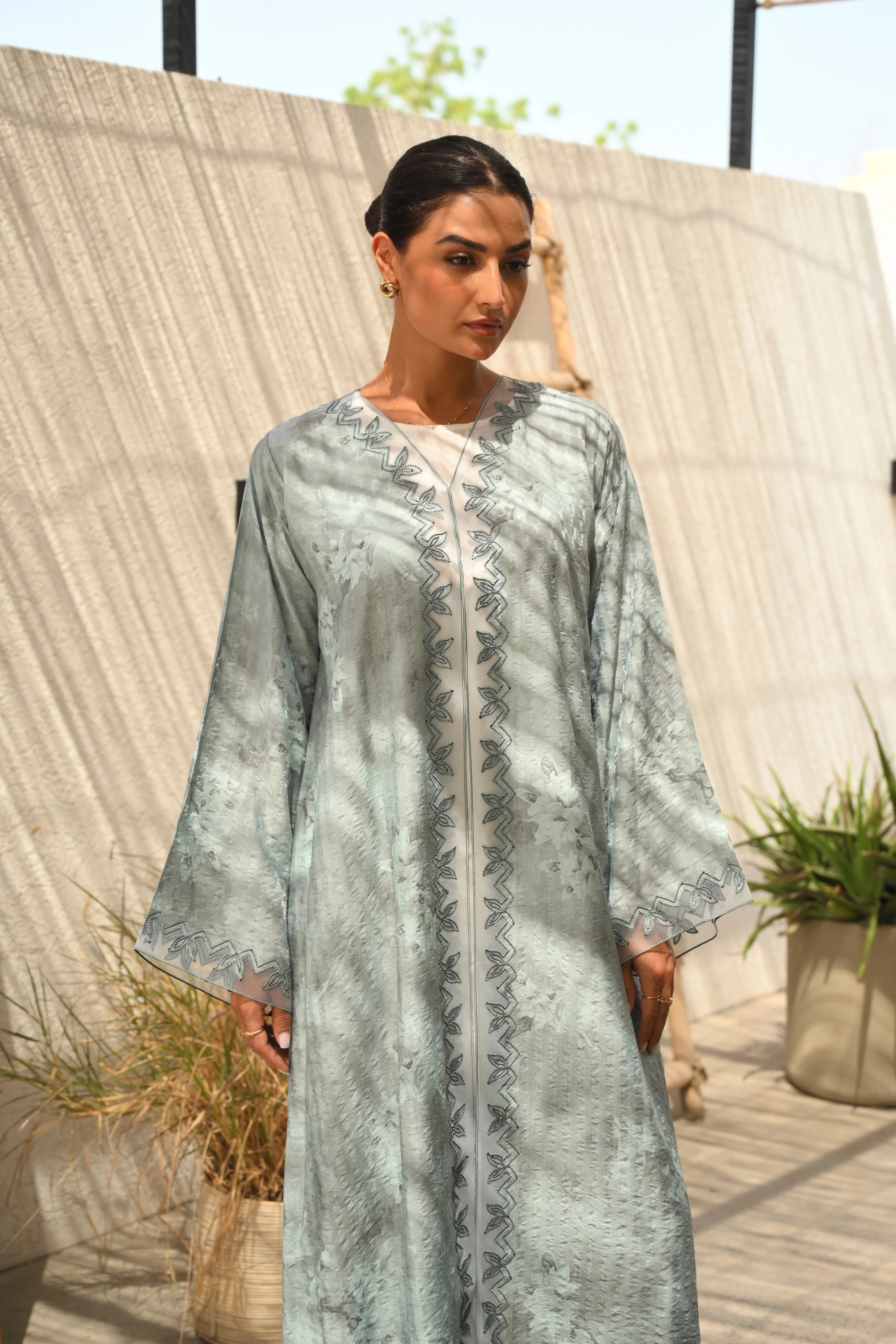 Luxury turquoise tie-dye abaya with elegant Dori embroidery and laser-cut details on the front and sleeves