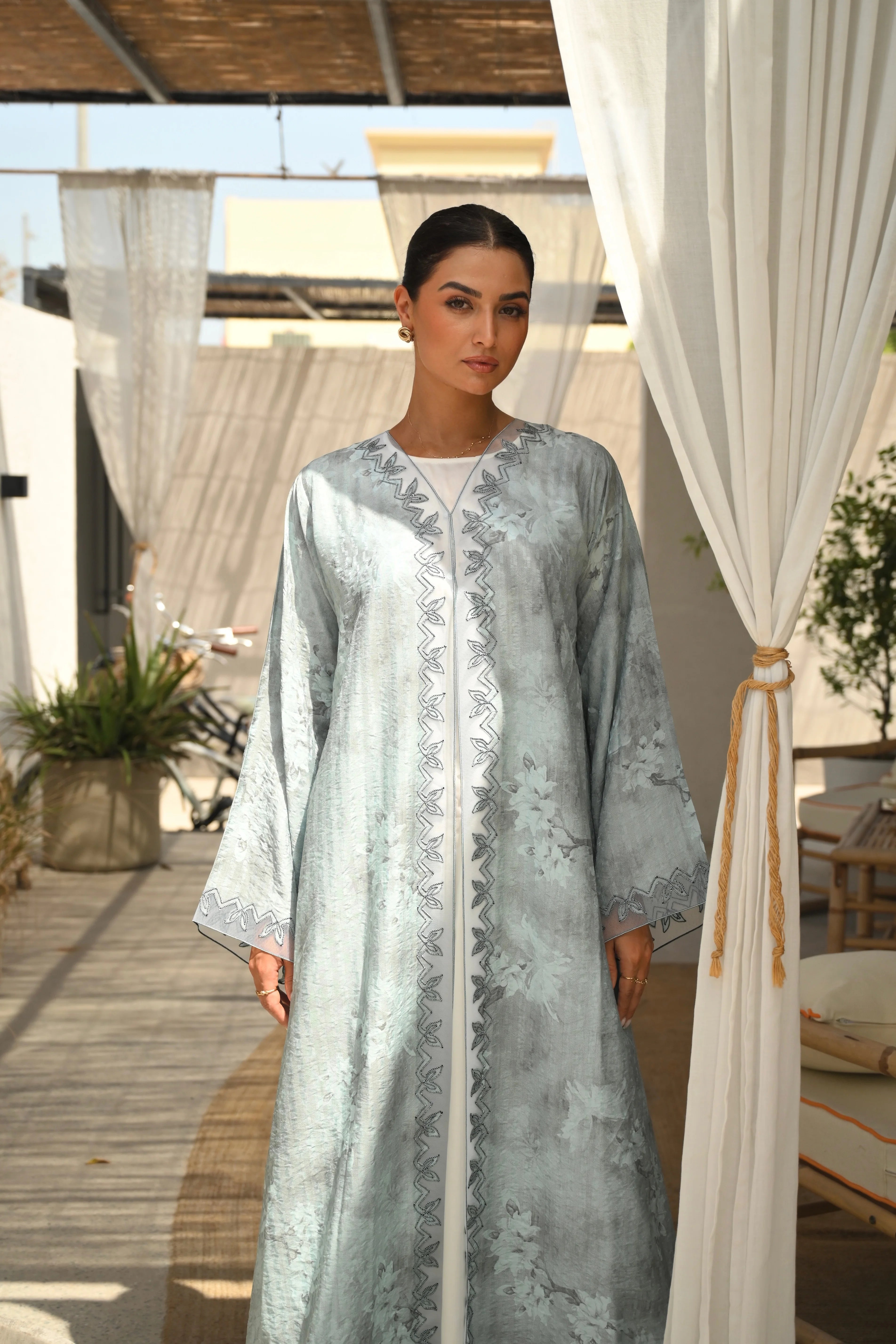 Luxury turquoise tie-dye abaya with elegant Dori embroidery and laser-cut details on the front and sleeves