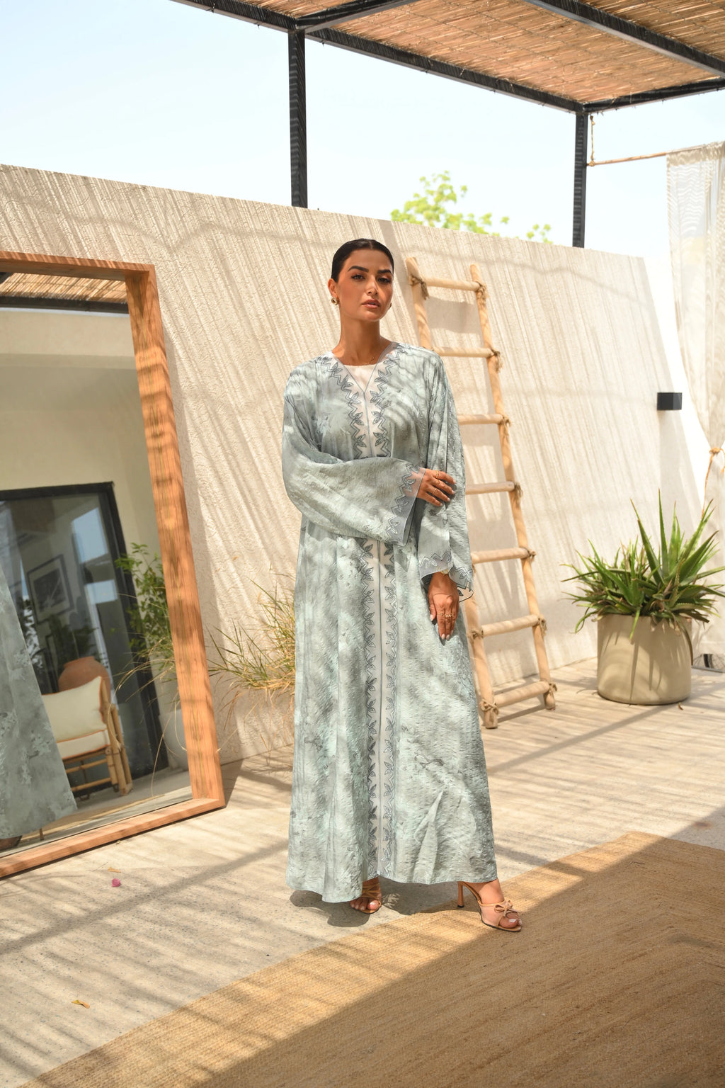 Luxury turquoise tie-dye abaya with elegant Dori embroidery and laser-cut details on the front and sleeves
