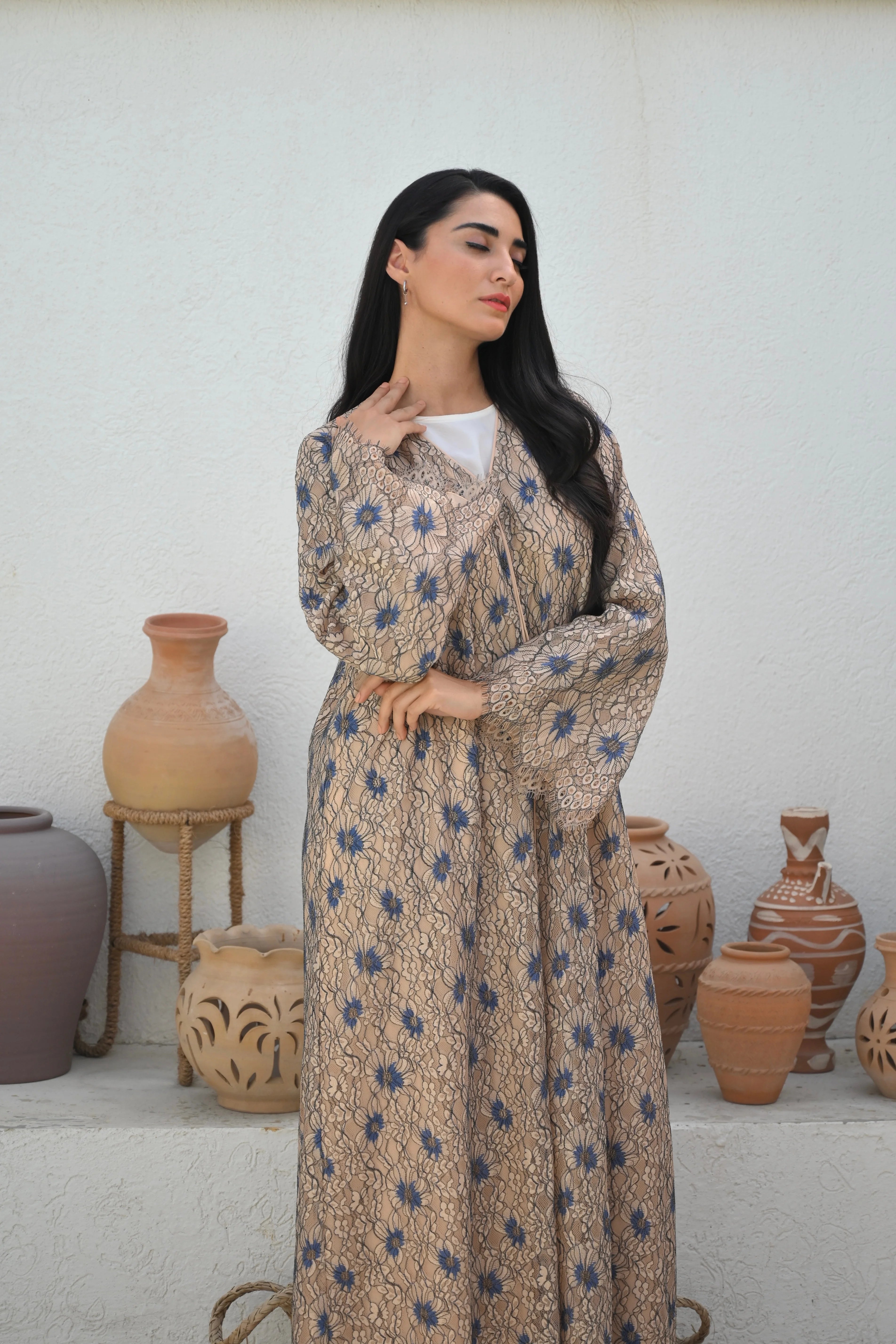 Luxury floral lace abaya with blue flower details and elegant flowing Emirati design