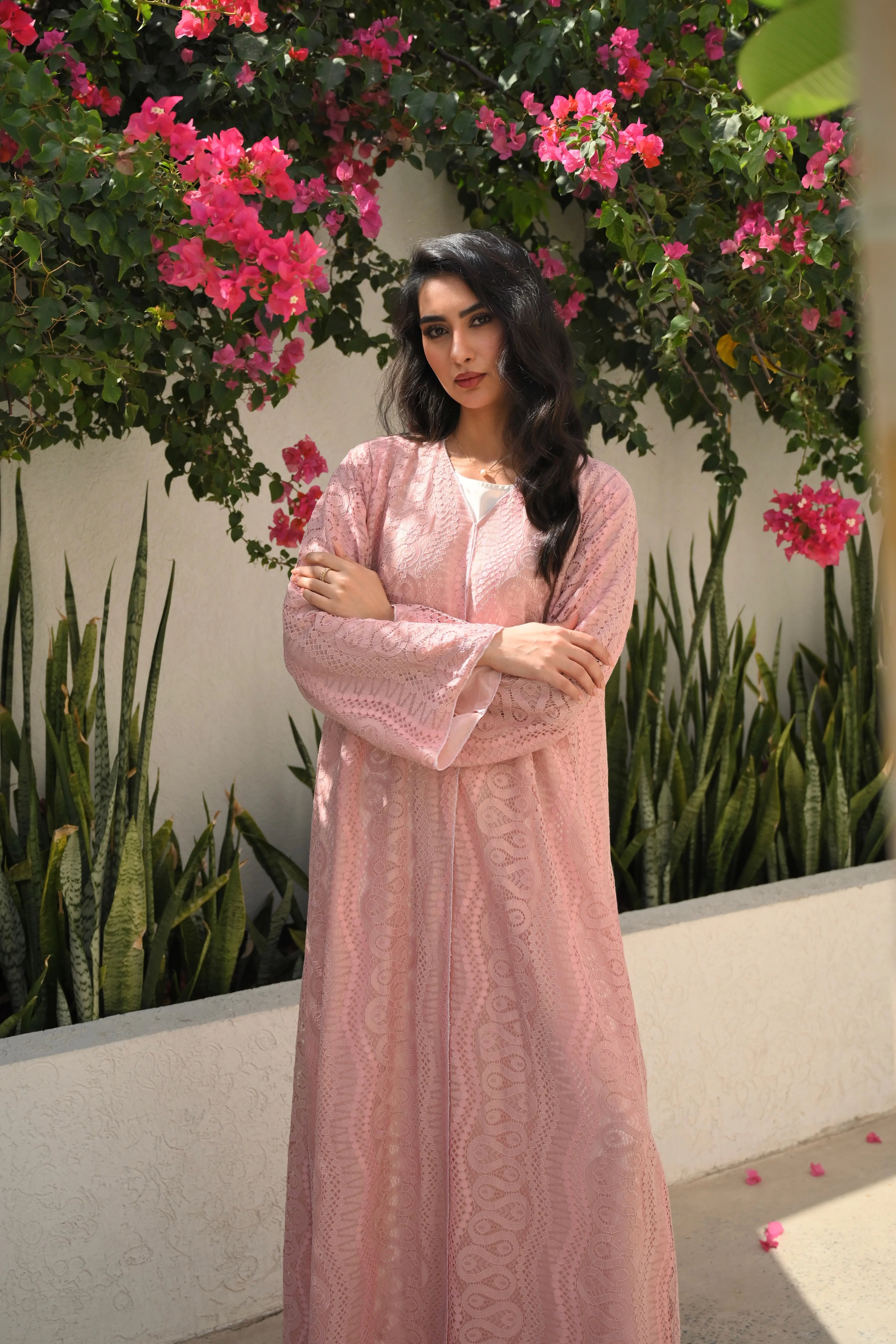 Luxury light pink lace abaya with elegant floral lace details and flowing sleeves