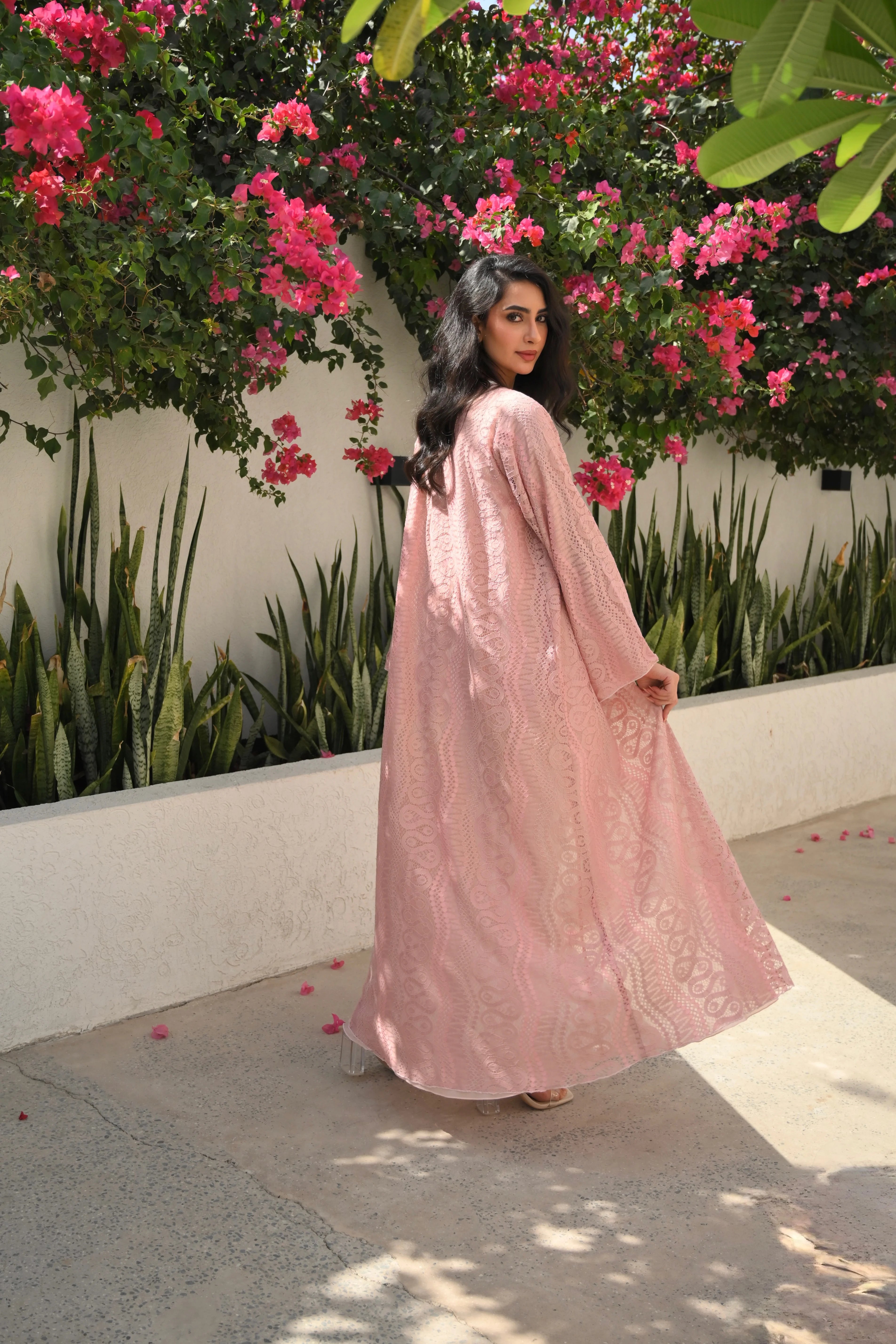 Luxury light pink lace abaya with elegant floral lace details and flowing sleeves