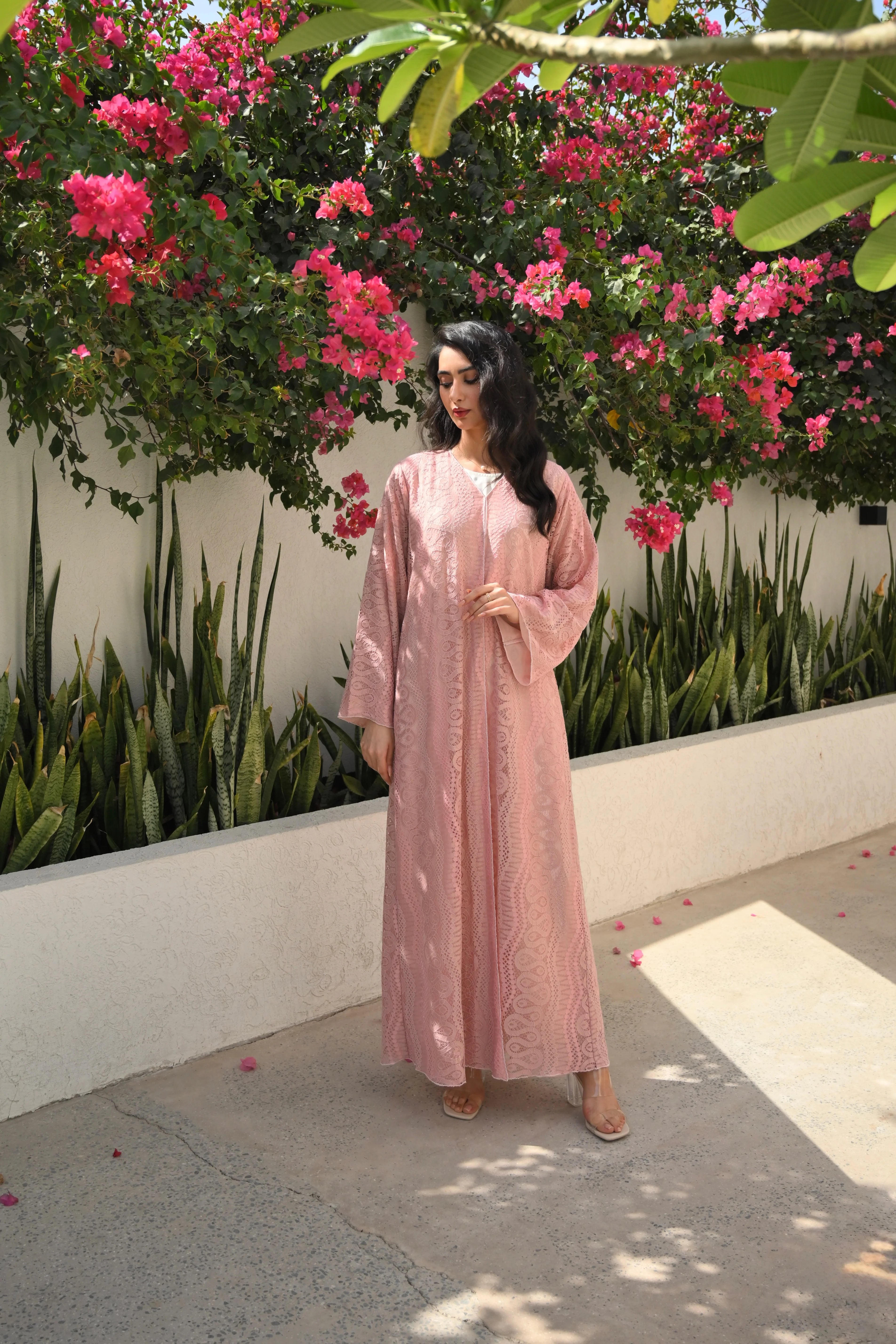 Luxury light pink lace abaya with elegant floral lace details and flowing sleeves