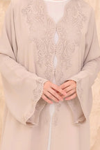 Elegant beige abaya front view — laser-cut detail and crystal Al Anood UAE