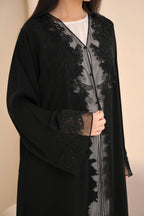 Elegant black abaya front view — floral embroidery and picot trim Al Anood