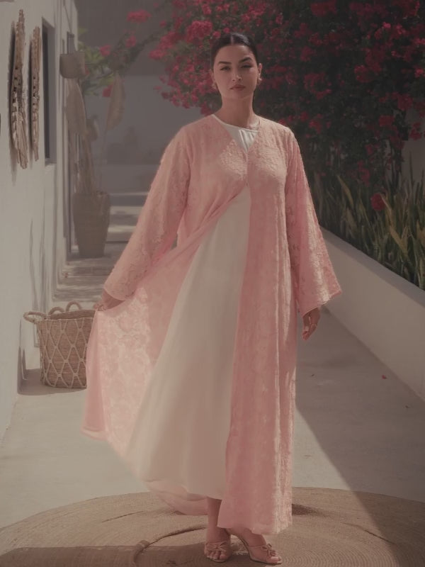 Luxury light pink lace abaya with elegant floral lace details and flowing sleeves 