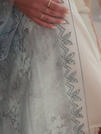 Luxury turquoise tie-dye abaya with elegant Dori embroidery and laser-cut details on the front and sleeves