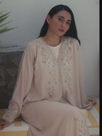 Soft beige Emirati abaya with laser embroidery on the chest and sleeves