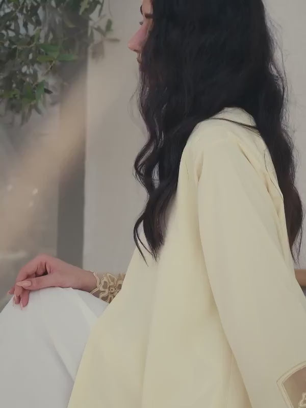 Light yellow Emirati abaya with laser cut details and Dori embroidery on sleeves and side panels